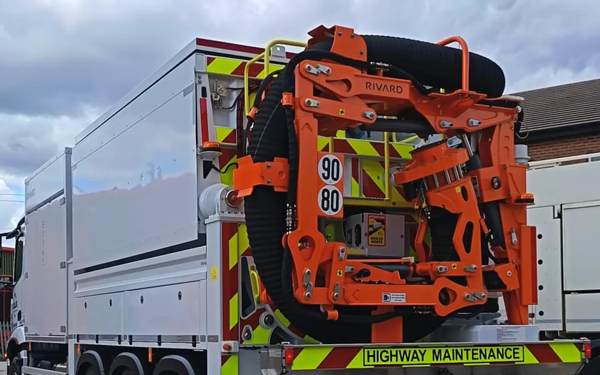 The rear of the Rivard with its suction boom folded, chevrons and highway maintenance signage